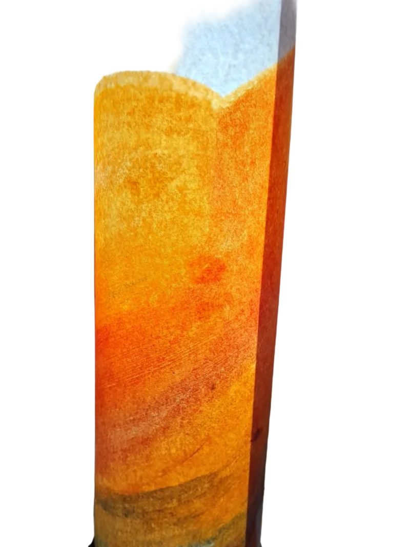 Tall cylindrical lamp with orange and brown gradient on a white surface.