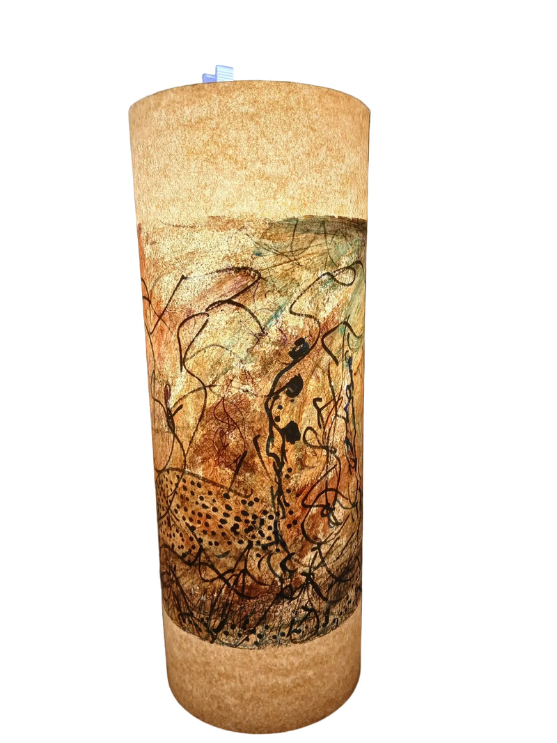 Cylindrical object with artistic design on a dark background